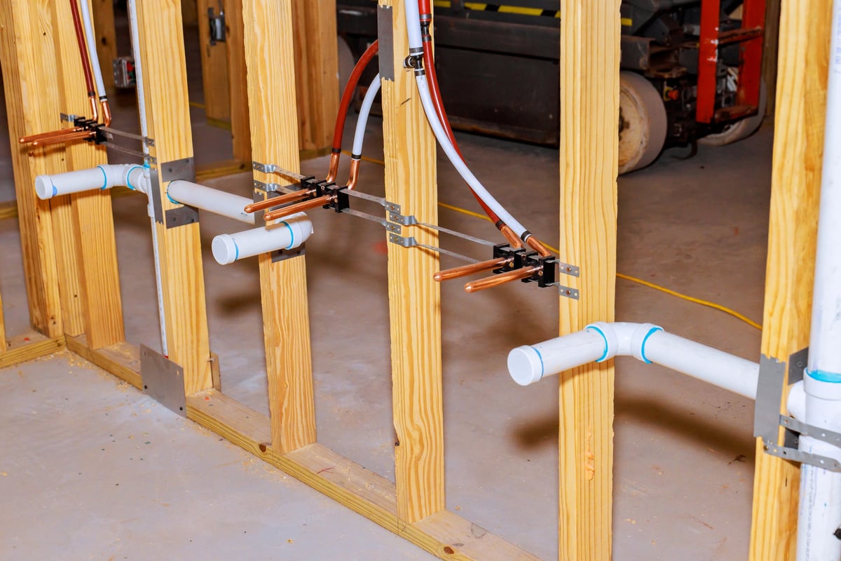 Copper, PVC pipes being installed in new construction